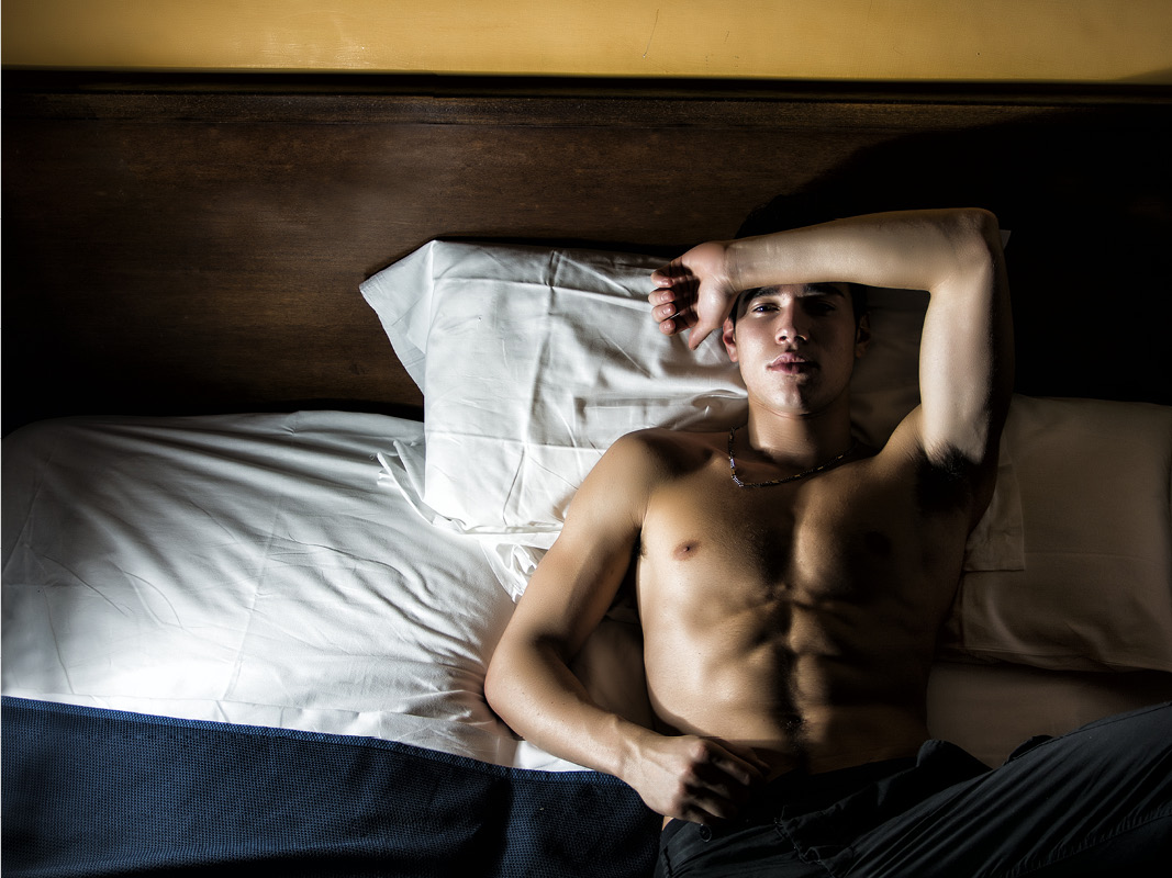 Young man laying awake in bed